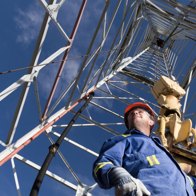 Worker standing under tower