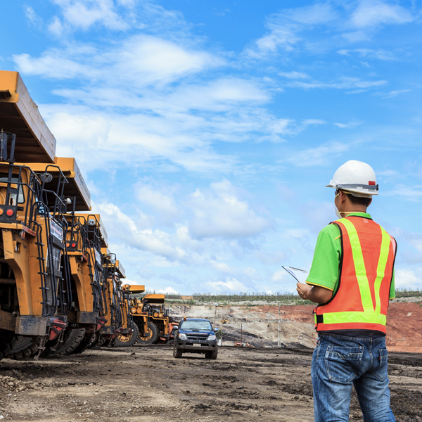 Miner standing in front of machines